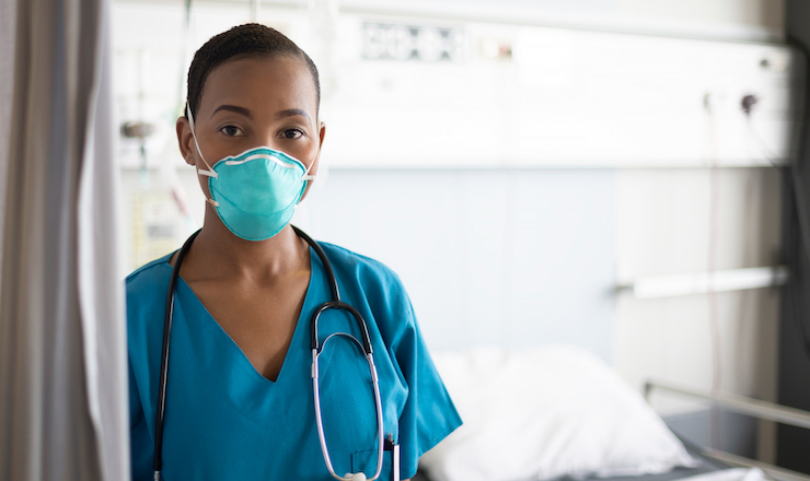Integrating IEHPs into the Health Care Workforce Lead Image: Photo of a nurse standing in a hospital room